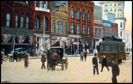 An automobile, a horse-drawn buggy, and an electric streetcar in early twentieth-century downtown Atlanta.
