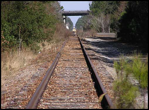 View up tracks to highway bridge over the rails
